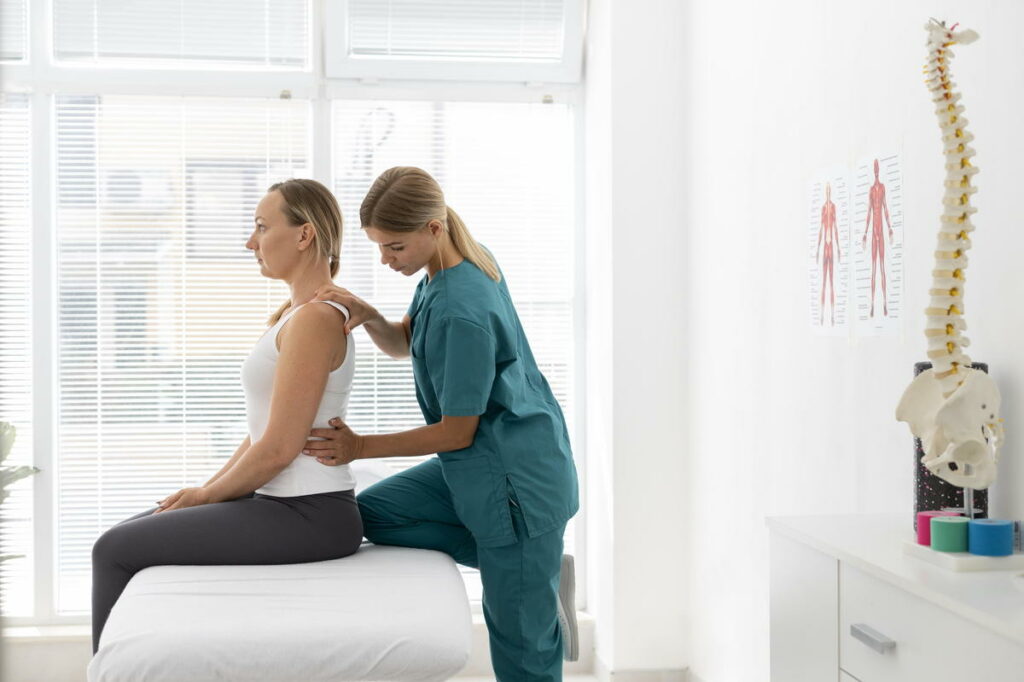 Chiropractor screening a patient for possible Scoliosis session.